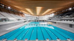 The Aquatics Centre: A Solar-Powered Marvel  in Paris 2024 Olympics To respond to environmental protection, 95% of the venues have been renovated from the old ones. Among them, the only brand-new competition venue The Aquatics Centre. The Aquatics Centre serves as a remarkable example of sustainable design. Not only is it powered by solar energy, but it also utilizes natural bio-based building materials and recycled ones.